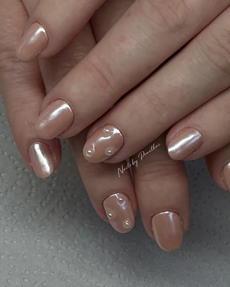 Short nude chrome nails with tiny pearl details